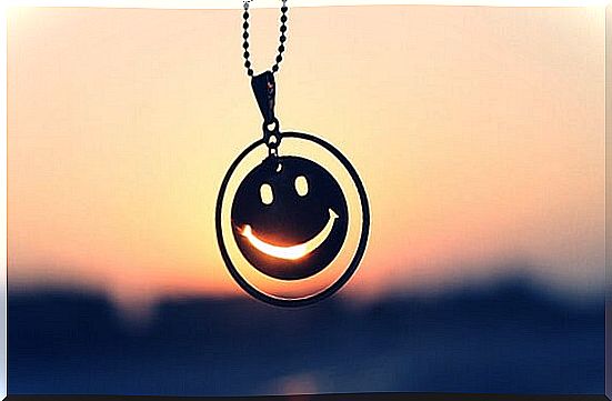 pendant in the shape of a smile representing the act of learning to laugh at oneself