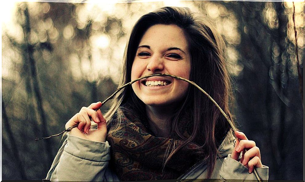 Girl smiling with tree branch