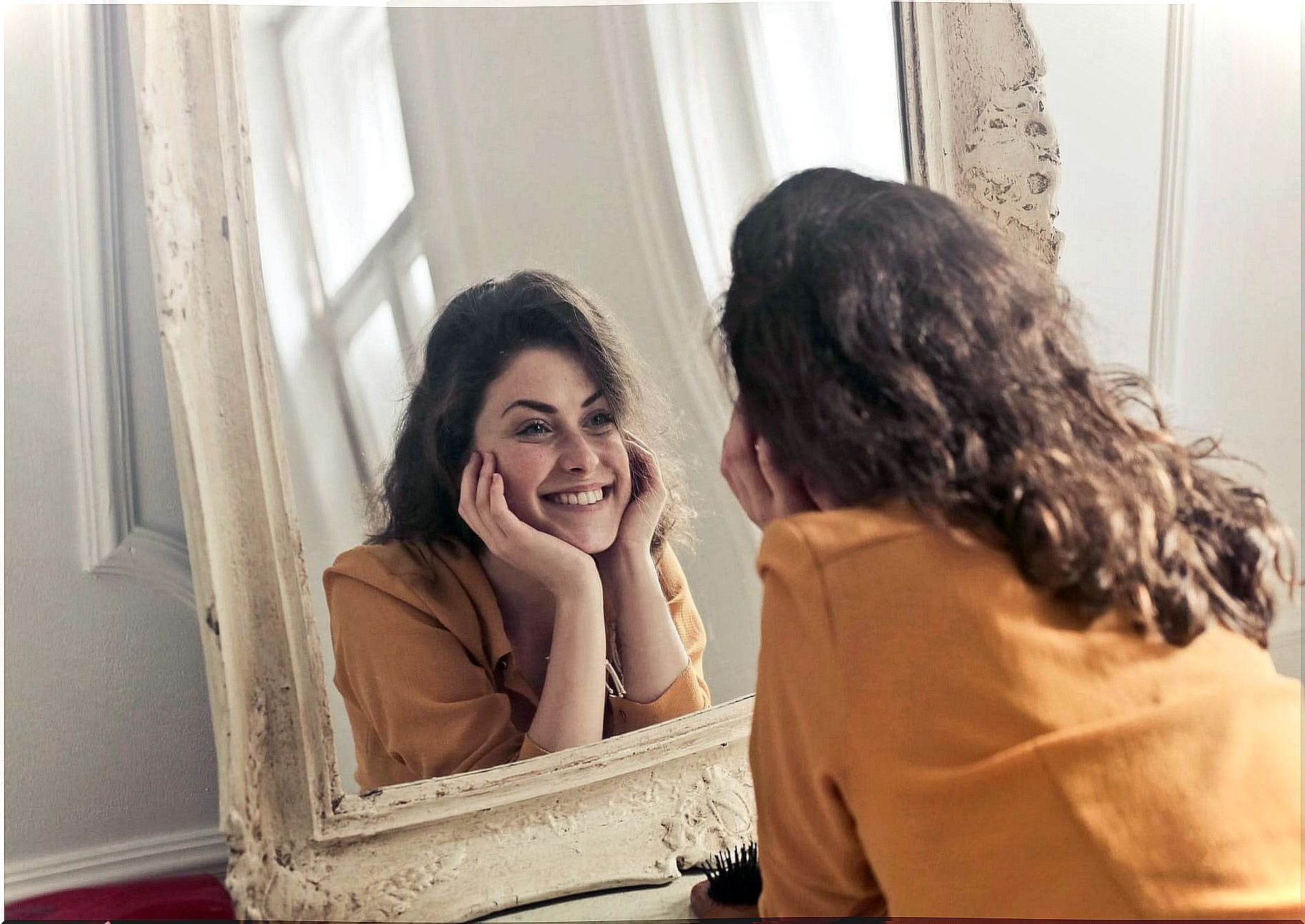 smiling woman looking at mirror