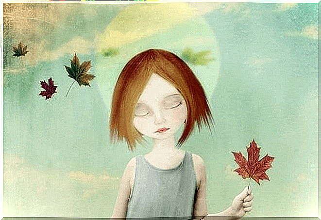 Sad girl with dry leaf in hand