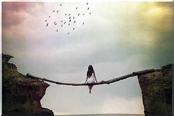 woman sitting on a log and suspended in an abyss symbolizing the art of being good with yourself