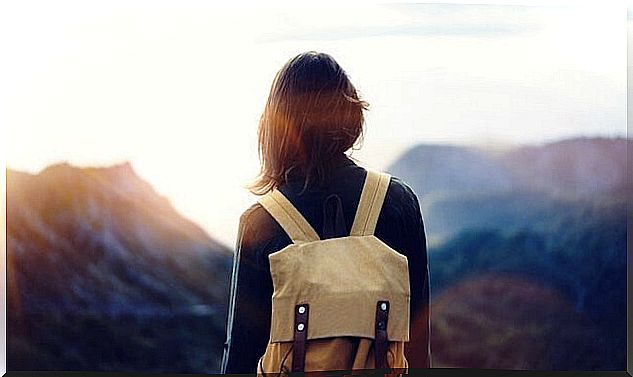 Girl with backpack enjoying the pleasure of traveling alone