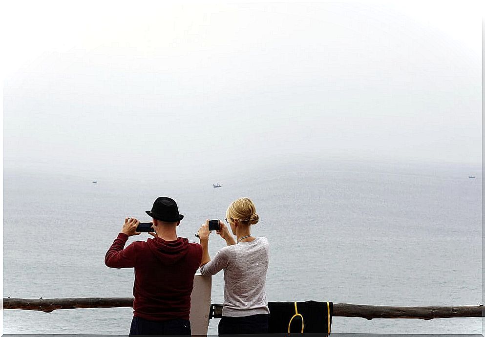 Couple with mobile taking photos