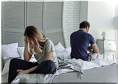 Couple turning their backs in bed