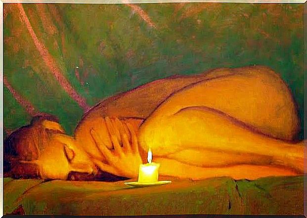 woman lying in front of a candle