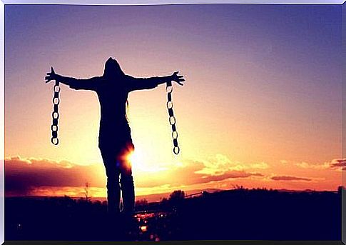 Free woman breaking free from her chains