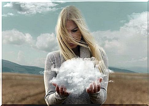 Woman holding a cloud with her hands