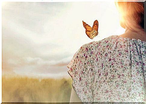 Woman with a butterfly on her shoulder thinking that everything changes
