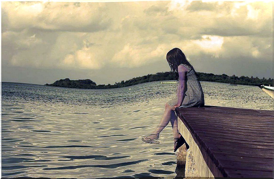 Girl alone on the pier symbolizing the wound of parents who abandon their children
