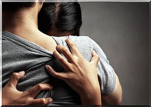 Crying woman hugging her partner