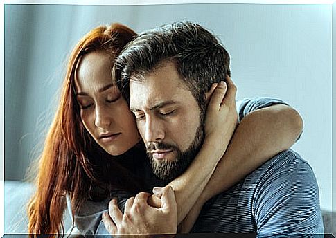Couple embracing with eyes closed