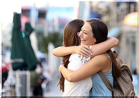 Girlfriends hugging in the street