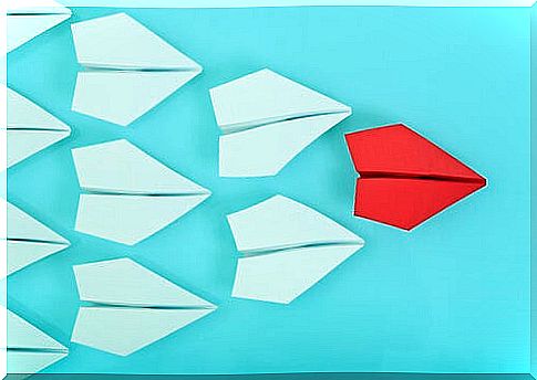 Red paper plane representing a leader