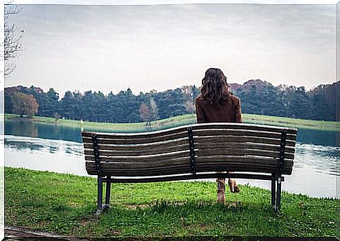Lonely woman sitting on a park bench