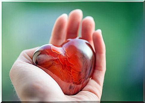Hand holding a glass heart